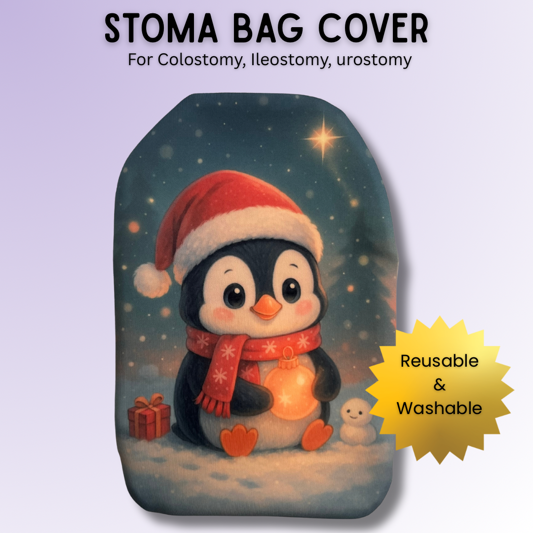 Adorable festive penguin stoma bag cover wearing a Santa hat and scarf, holding a glowing bauble in the snow – cute Christmas ostomy cover.